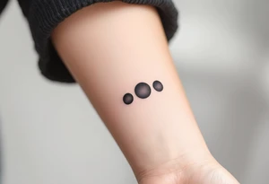 Three charcoal black dots tattoo idea