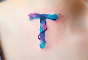 A watercolor-style "T" in shades of turquoise and purple, blending like paint strokes. tattoo idea