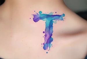 A watercolor-style "T" in shades of turquoise and purple, blending like paint strokes. tattoo idea