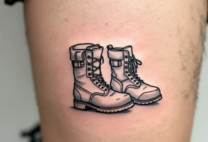 A pair of boots—one large, one tiny—side by side, outlined in black with a faint dusty blue shadow for depth. tattoo idea