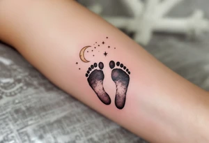 Soft peach and white footprints of Laura, with a whimsical moon cradling the prints, as a reminder of her gentle dreams. tattoo idea