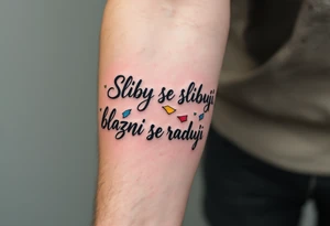 "Sliby se slibuji, blazni se raduji." — A string of colorful paper promises fluttering away in the wind, with the quote wrapped around in playful gray cursive. tattoo idea