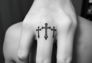 3 crosses side by side to form what looks like a ring on top of the 4th finger. elegant, simple tattoo idea