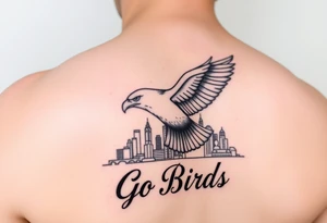 Tattoo On upper bicep 
Philadelphia Eagle classic bird flying over Philadelphia city skyline with the words Go Birds under it tattoo idea