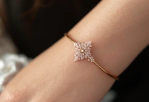 A thin, delicate gold ring with intricate white filigree engravings, symbolizing timeless elegance and devotion. tattoo idea