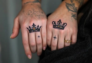 Minimalist black king and queen crowns with gold and silver accents on the outer hands of couple celebrate your royal bond. tattoo idea