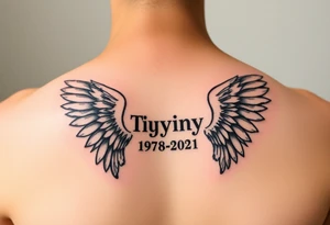 Simple Angle wings with Tiffany in the middle and 1978-2021 under it tattoo idea