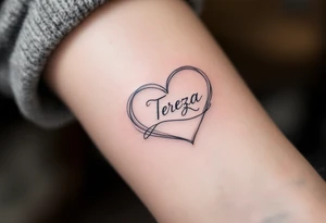 A delicate, outline heart with a flowing ribbon, containing the name "Tereza" in elegant cursive, with soft pastel pink and gold accents. tattoo idea