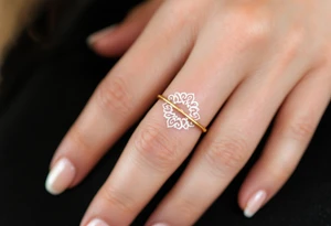 A thin, delicate gold ring tattoo with intricate white filigree engravings, symbolizing timeless elegance and devotion. tattoo idea