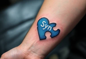 A puzzle piece in bright blue labeled “Syn,” fitted perfectly into a black outline of a heart. tattoo idea