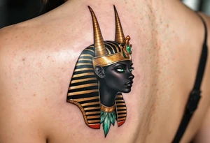 A black Anubis head with emerald green eyes and a royal gold headdress. tattoo idea