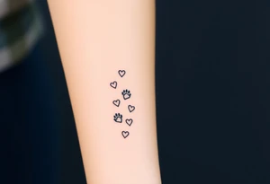 a lineal path of cat paw prints and hearts following the path tattoo idea