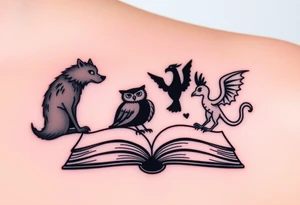 An open book with black silhouettes of a werewolf, an owl, a dragon & a phoenix coming out of the book tattoo idea