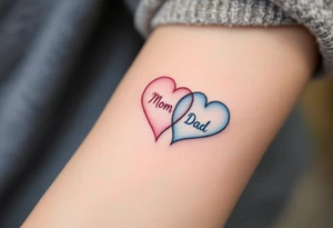A split heart tattoo: one side in soft pink labeled “Mom,” the other in sky blue labeled “Dad.” tattoo idea