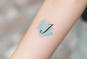 Minimalist thin-line "J" in crisp black, floating above a soft watercolor teal splash. tattoo idea