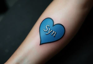 A puzzle piece in bright blue labeled “Syn,” fitted perfectly into a black outline of a heart. tattoo idea