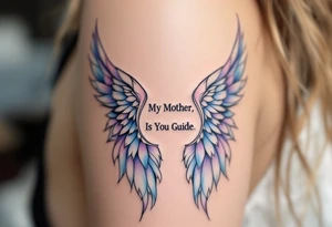 A pair of angel wings in light blue and lavender with “My Mother, Is My Guide” between them. tattoo idea