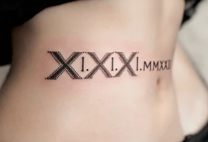 Elegant XXI.XI.MMXII in dark gray ink across the ribs, styled with subtle shadowing for a stone-carved effect. tattoo idea