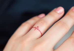 A tiny, delicate red finger band tattoo idea