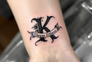 Old English K in matte black, resting on a scroll banner with gray shading, reminiscent of medieval heraldry. tattoo idea