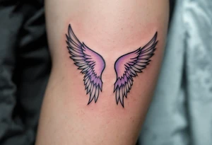 pair of angel wings enclosing "Linda – 1.1.2016 v 0:01", done in light gray and faded lilac. tattoo idea