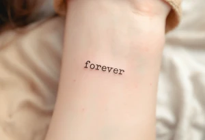 A simple "forever" in lowercase typewriter font with a muted brown ink, vintage style. tattoo idea