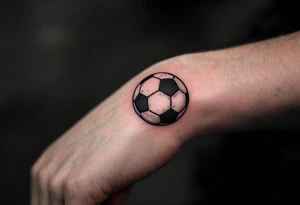 A simple red soccer ball icon on the wrist for a subtle, bold statement. tattoo idea