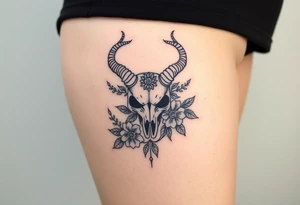 The sign capricorn as a realistic skull with leaves and flowers tattoo idea