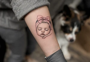 A portrait-style tattoo of a sleeping baby girl’s face, realistic shading in grayscale with a pink bow headband as the only color. tattoo idea
