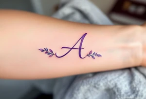 A delicate cursive "A" in soft lavender ink with a watercolor wash. tattoo idea