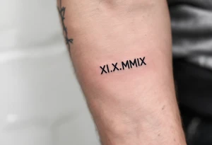 XI.XI.MMIX inked in matte black on the hand’s edge, accompanied by silver barbed wire surrounding it. tattoo idea