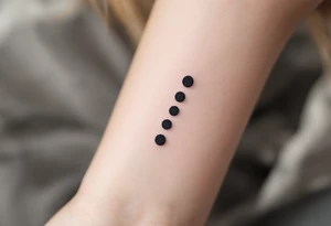 Three charcoal black dots forming a vertical ellipsis. tattoo idea