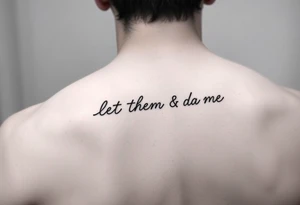 Small Fine line dainty cursive tattoo with the saying “let them & let me” tattoo idea