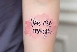 “You are enough” in dusty rose with a faint watercolor background of pastel blues and pinks. tattoo idea