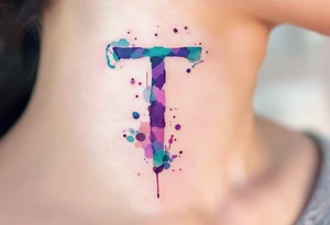 A watercolor-style "T" in shades of turquoise and purple, blending like paint strokes. tattoo idea
