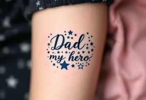 Bold black script saying “Dad, my hero” framed by navy blue stars. tattoo idea