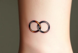 A delicate infinity symbol made of interlocking wedding rings, with soft metallic gold and silver tones tattoo idea