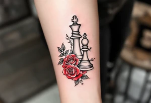 A fine-line black and gray tattoo of a chess king and queen piece intertwined with red roses. tattoo idea