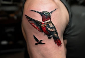 A hummingbird with one side appearing normal and the other side carved in Egyptian stone (red and black only) tattoo idea