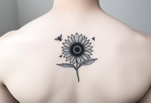 A book with a sunflower and bees as one page tattoo idea