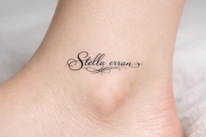 Delicate calligraphy of Stella erran on the inner ankle tattoo idea