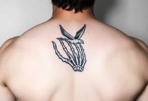 Skeleton hand reaching out of the ocean for a flying swallow in the Sailor Jerry style tattoo idea