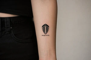 Koenigsegg ghost logo and below written "simply lovely" tattoo idea