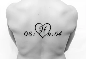 06-09-04 written and under it is a heart inside the heart is a letter H in cursive on the lower back waist tattoo idea