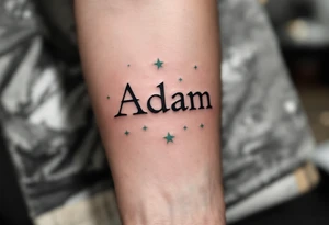 "Adam" written in typewriter font above 10.11.2015 v 20:50, with soft sage green stars around it. tattoo idea