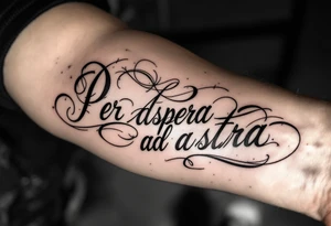 A black and gold script tattoo of “Per aspera ad astra” arcs across the forearm, symbolizing the beauty born from struggle. tattoo idea