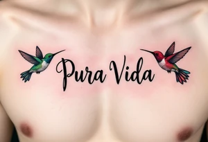 “Pura Vida” in handwritten font with two hummingbirds in emerald green and ruby red flanking the phrase. tattoo idea