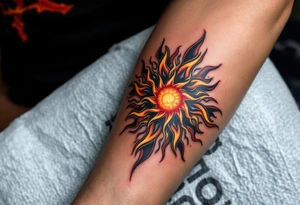 The fiery blend of red, yellow, and black in this Celtic sun tattoo creates a tribal blaze on the thigh. tattoo idea