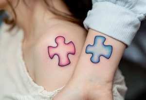 Interlocking puzzle pieces in soft pink and muted blue on the inner wrists symbolize how perfectly you fit together. tattoo idea