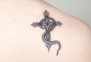 The cross impales the snake tattoo idea